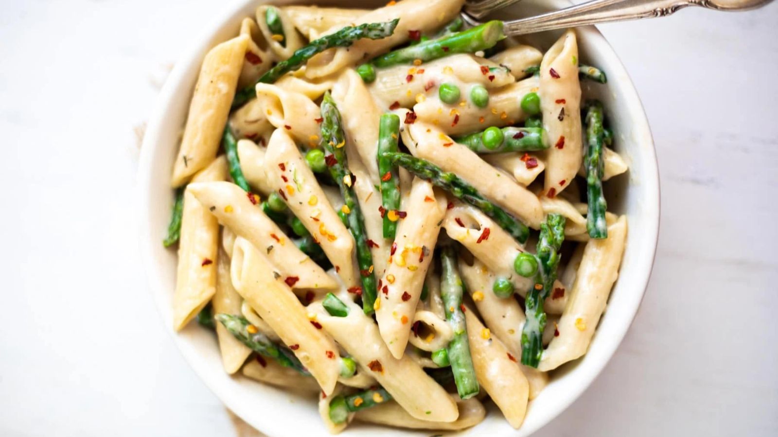 Penne pasta with asparagus, peas and hot pepper flakes. 