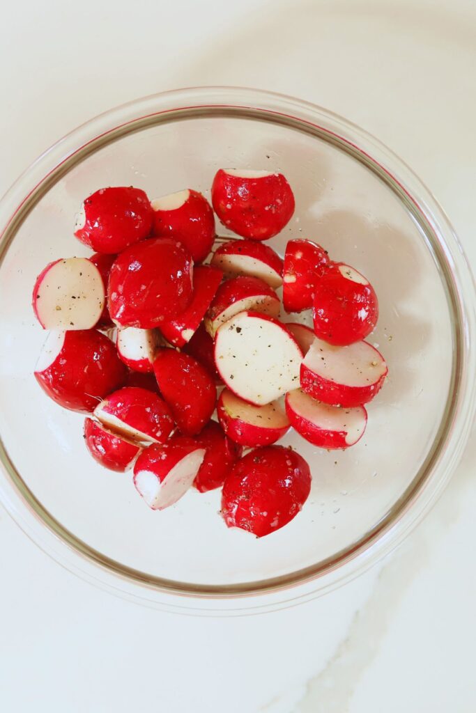 Salt, pepper, oil and radishes tossed together by hand. 