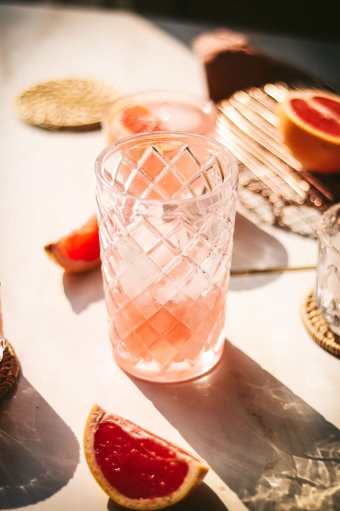 Cocktail shaker with lime juice and grapefruit juice. 