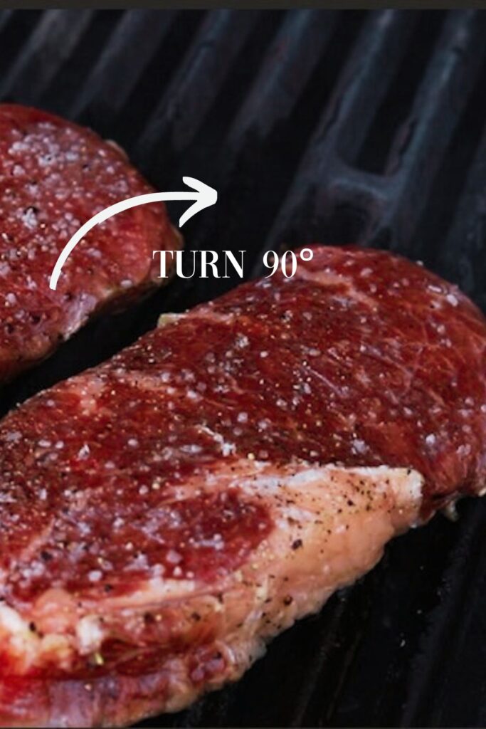 Steak turned 90 degrees on grill. 