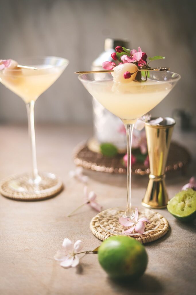 Two lychee martinis garnished with crab apple blossoms. 