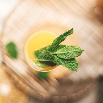 A mimosa mocktail (non-alcoholic) with fresh mint.