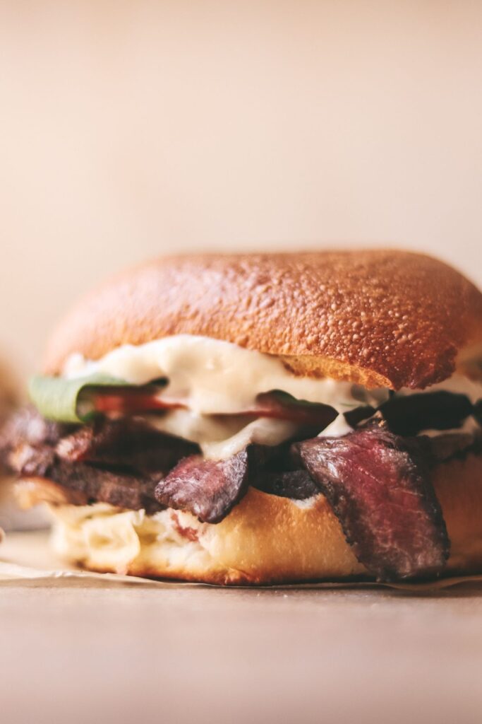 A steak sandwich with lots of mayo.