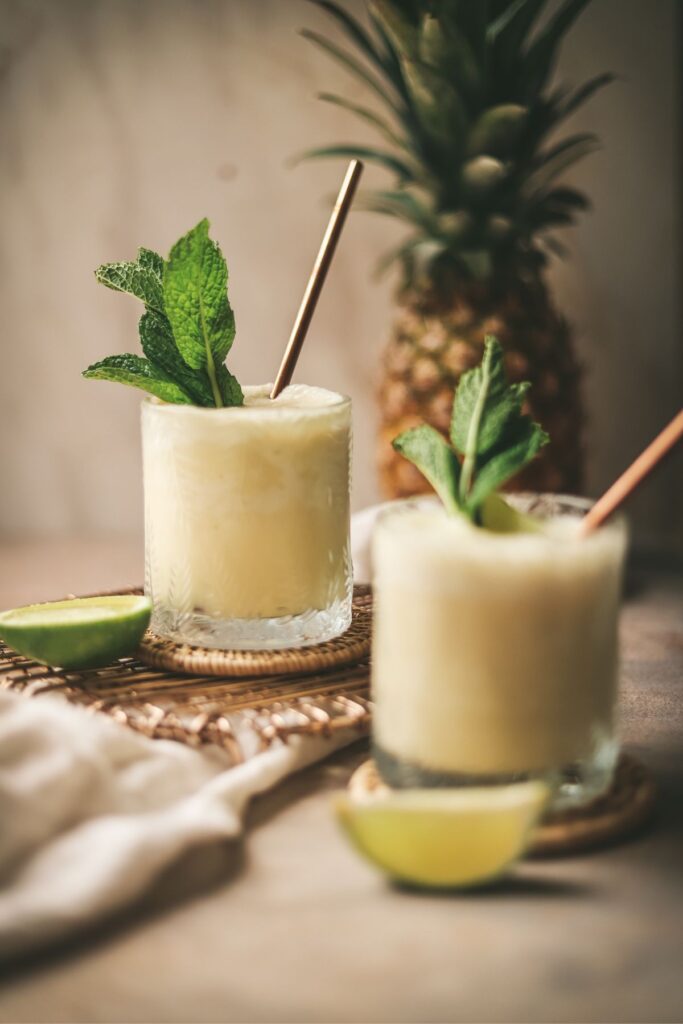 Two virgin pina coladas garnished with mint. 