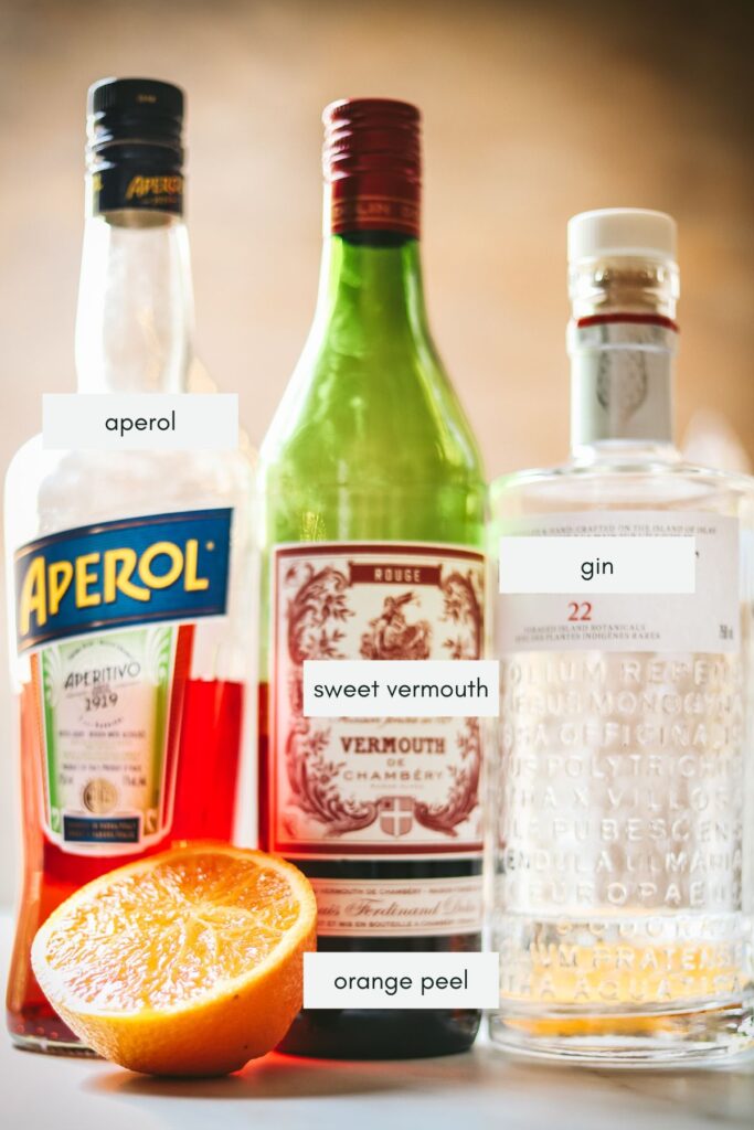 The ingredients for an aperol negroni, labeled. 