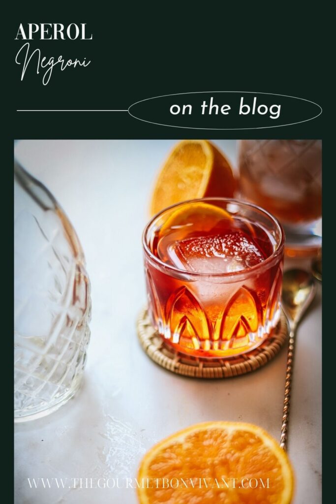 An aperol negroni cocktail with title text.