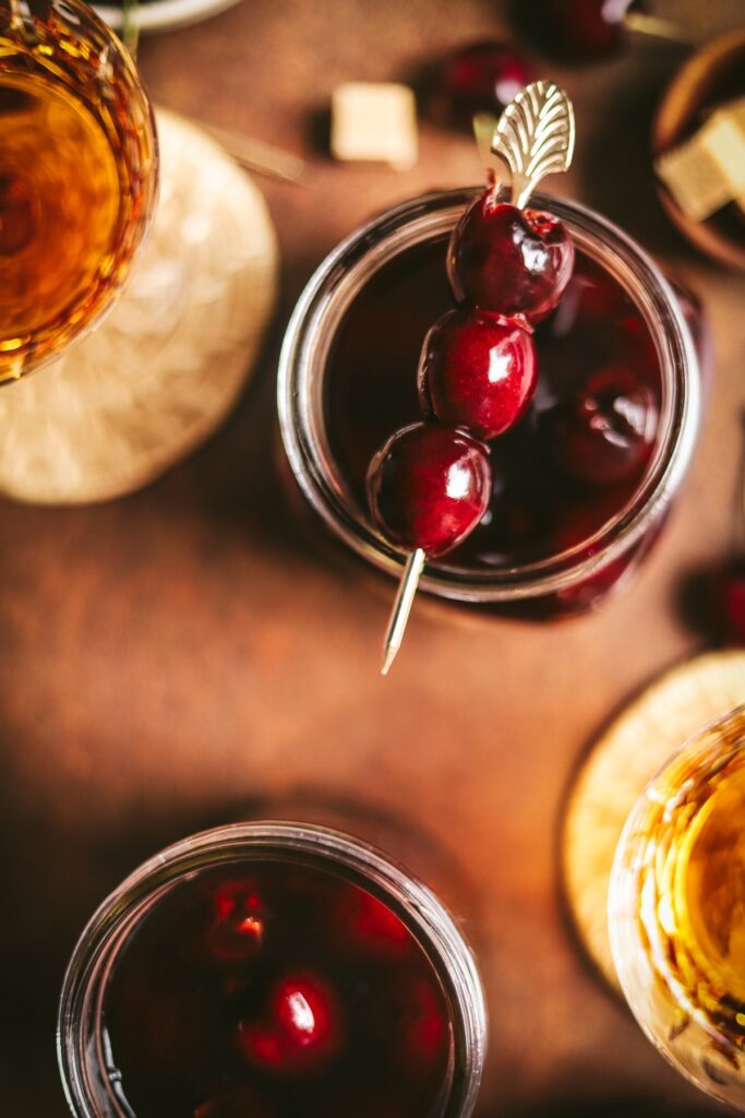 Cocktail cherries surrounded by amber alcohol. 