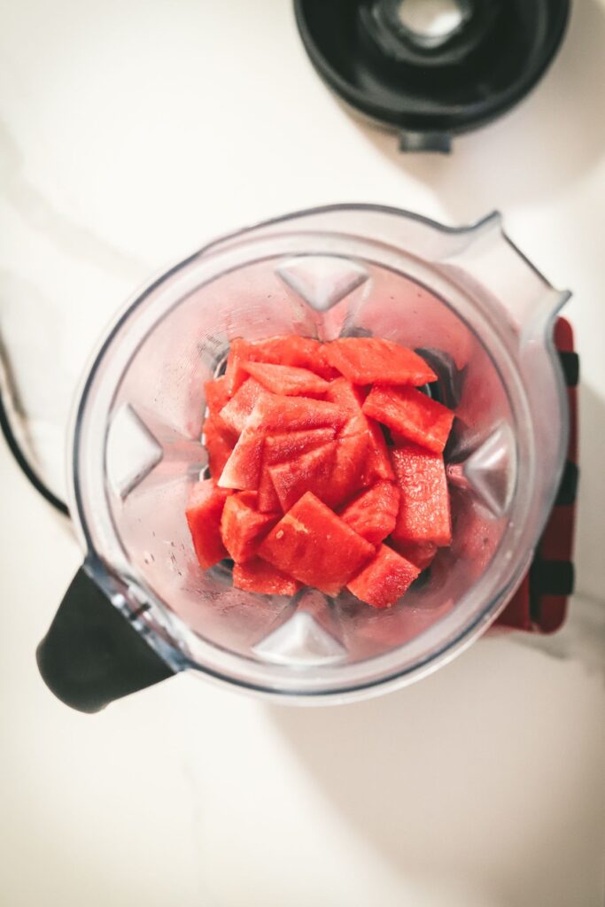 Chunks of watermelon in a blender. 