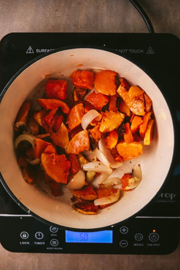 Roasted veggies added to the pot. 