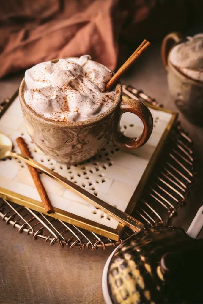 Maple cinnamon latte garnished with a cinnamon stick. 