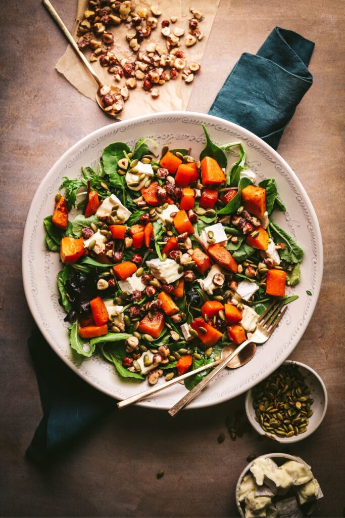 Roasted butternut squash salad with brie cheese and hazelnuts.