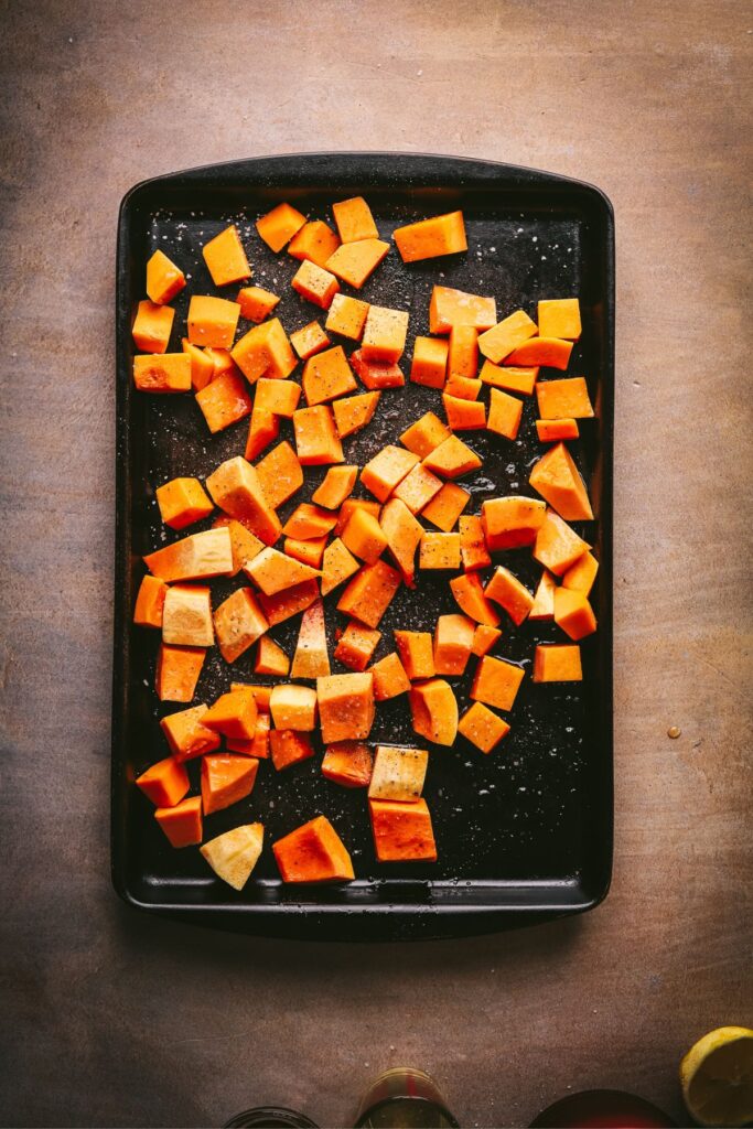 Maple roasted squash for the squash salad on a baking sheet. 