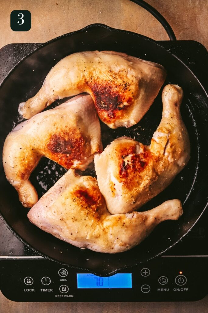 Searing the other side of the chicken in the skillet. 