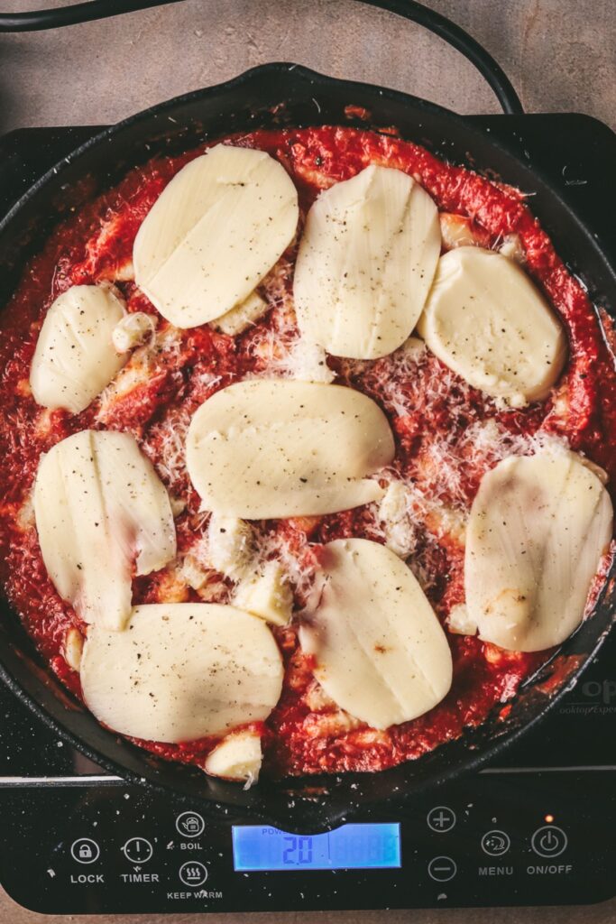 Mozzarella (sliced) layered over gnocchi and passata. 