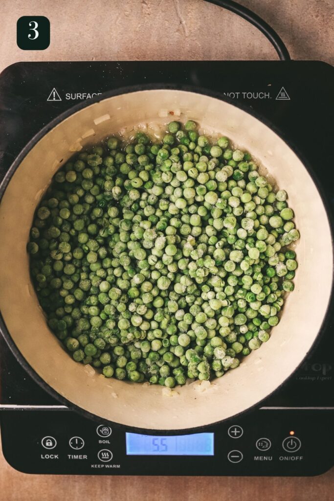 Adding frozen peas to the recipe. 
