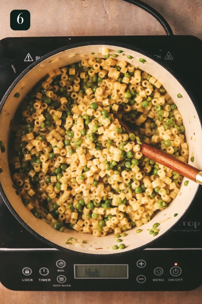 The pasta finishes cooking in the broth. 