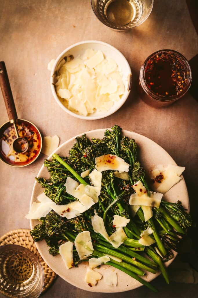 Broccolini surrounded parmesan cheese, hot honey and white wine.
