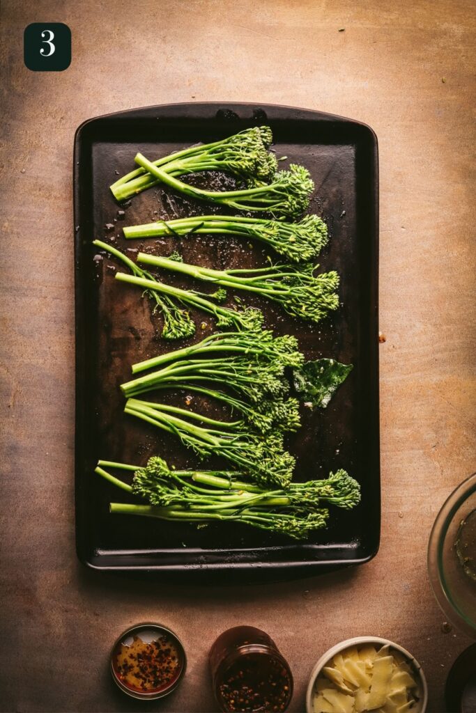 Broccolini in a single layer on a baking sheet. 