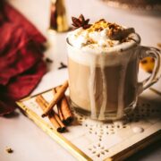 Gingerbread latte surrounded by spices.