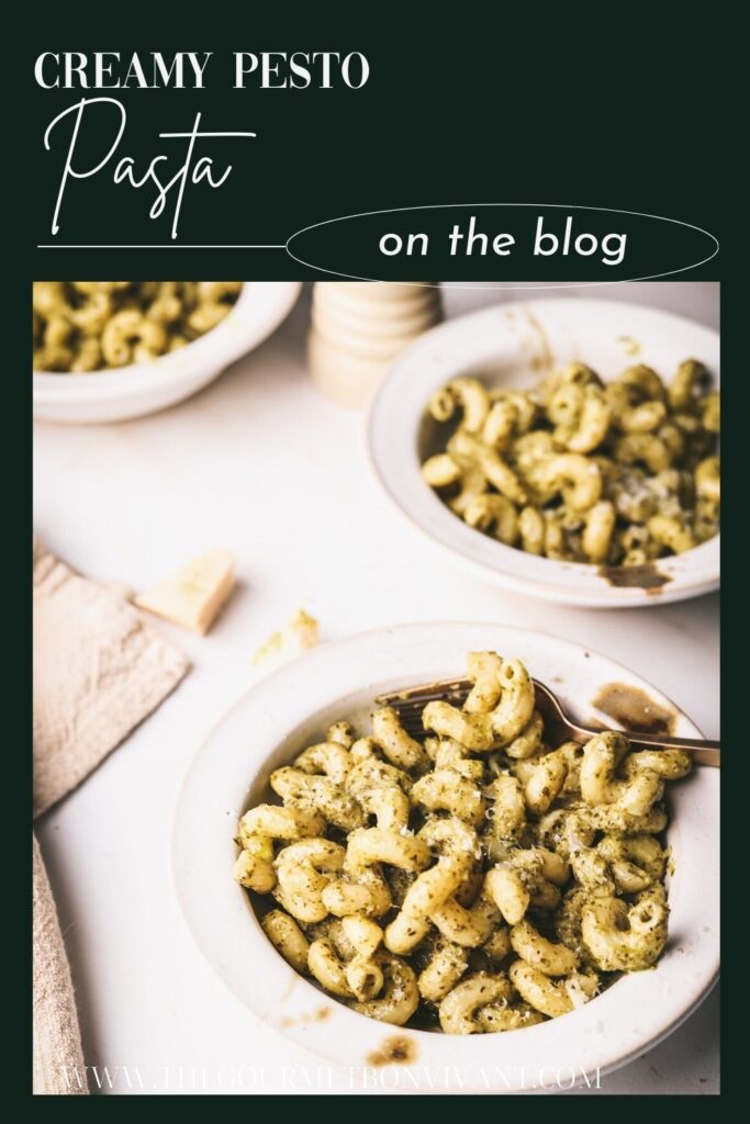 Green background pesto pasta cream sauce with title text.