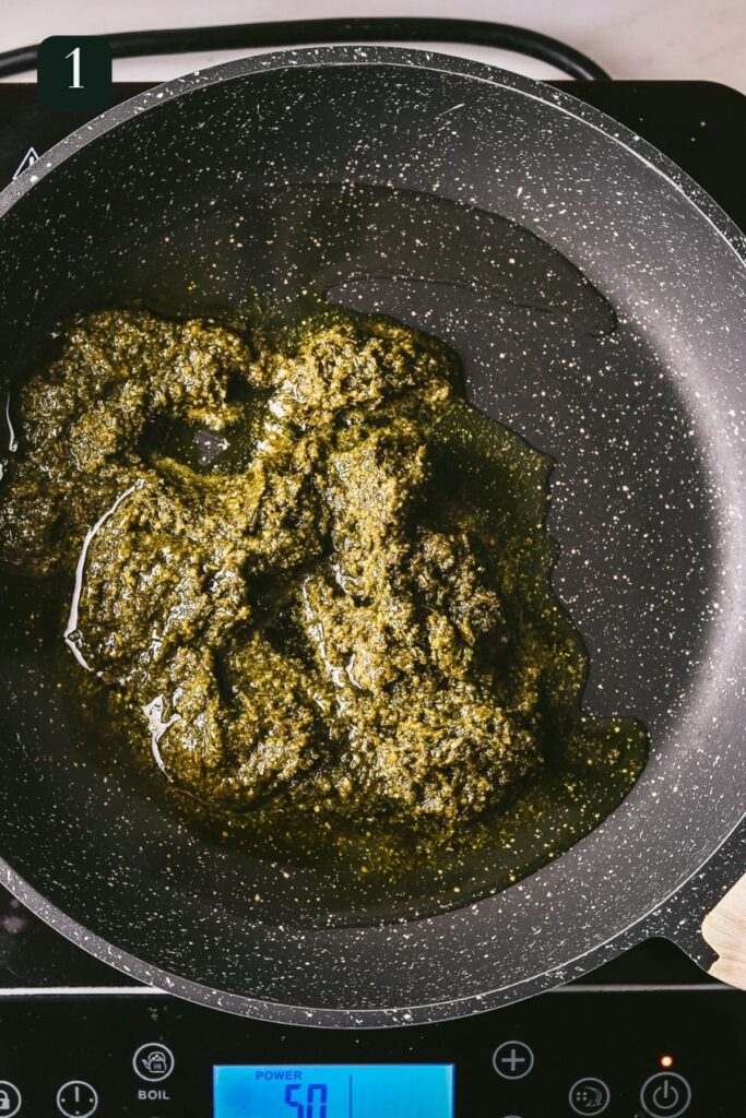 Pesto and olive oil being heated in a pan. 