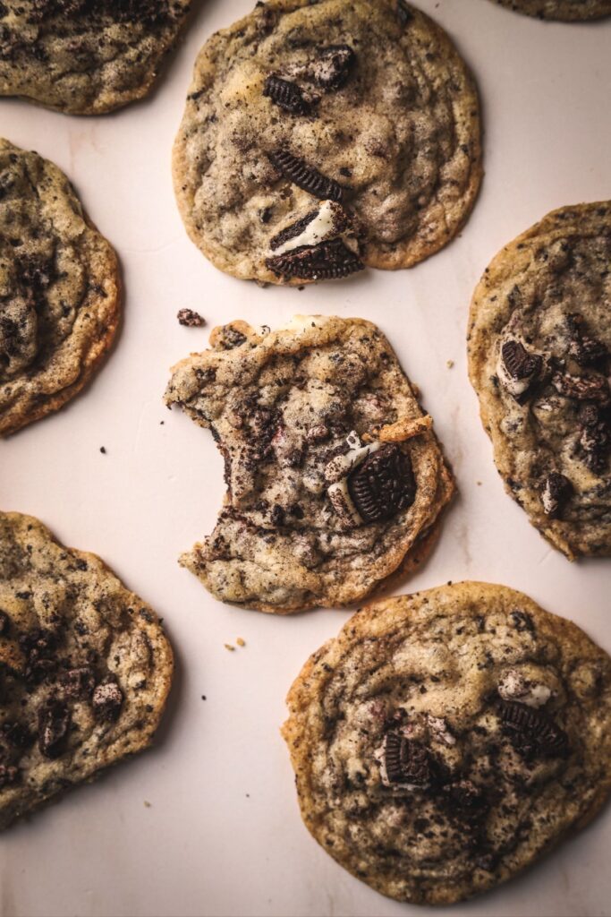 Chocolate chip oreo cookies with a bite out of one. 