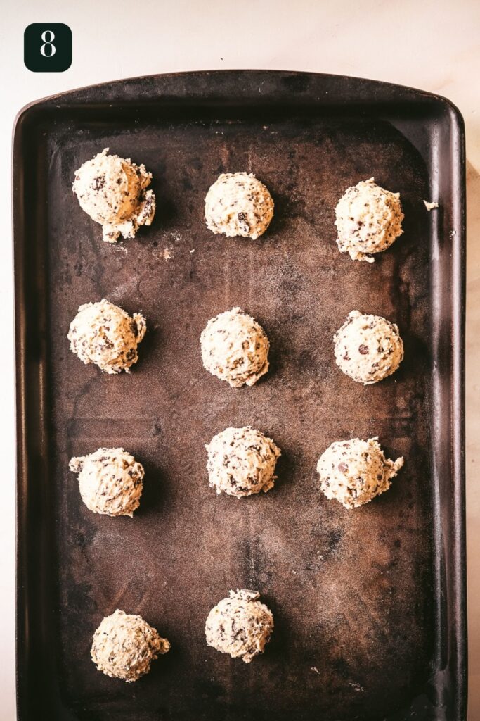 Cookie dough scooped on a baking sheet. 