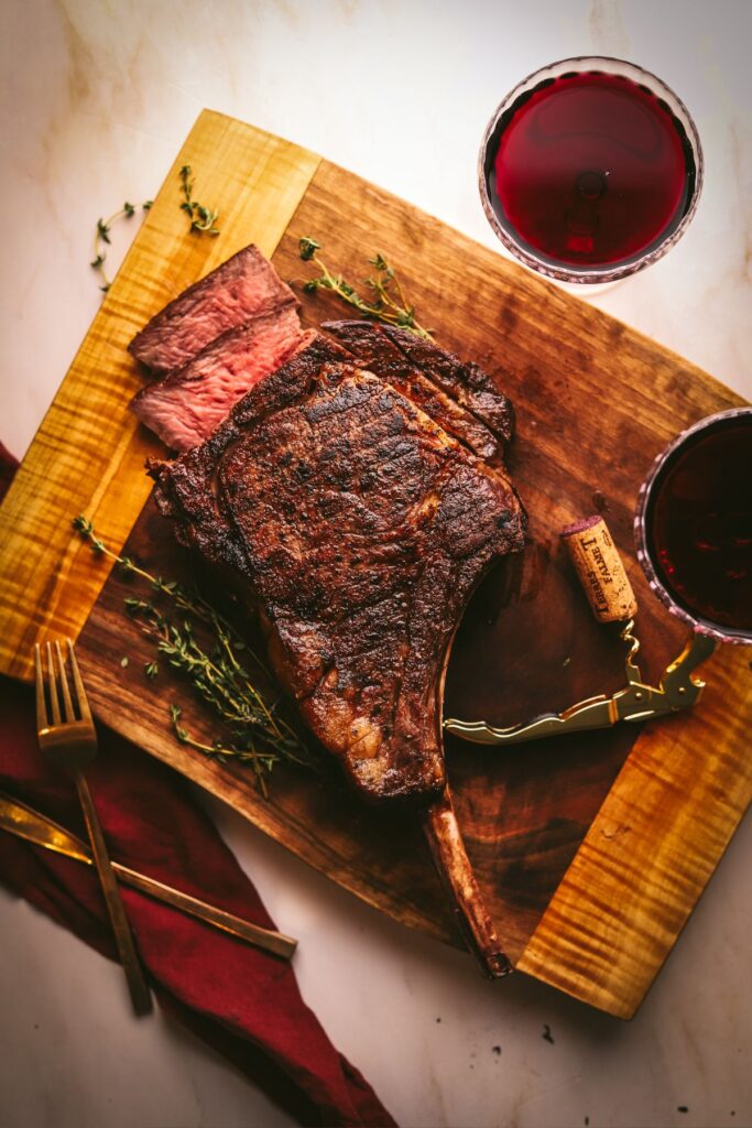 A seared tomahawk steak with red wine and thyme. 