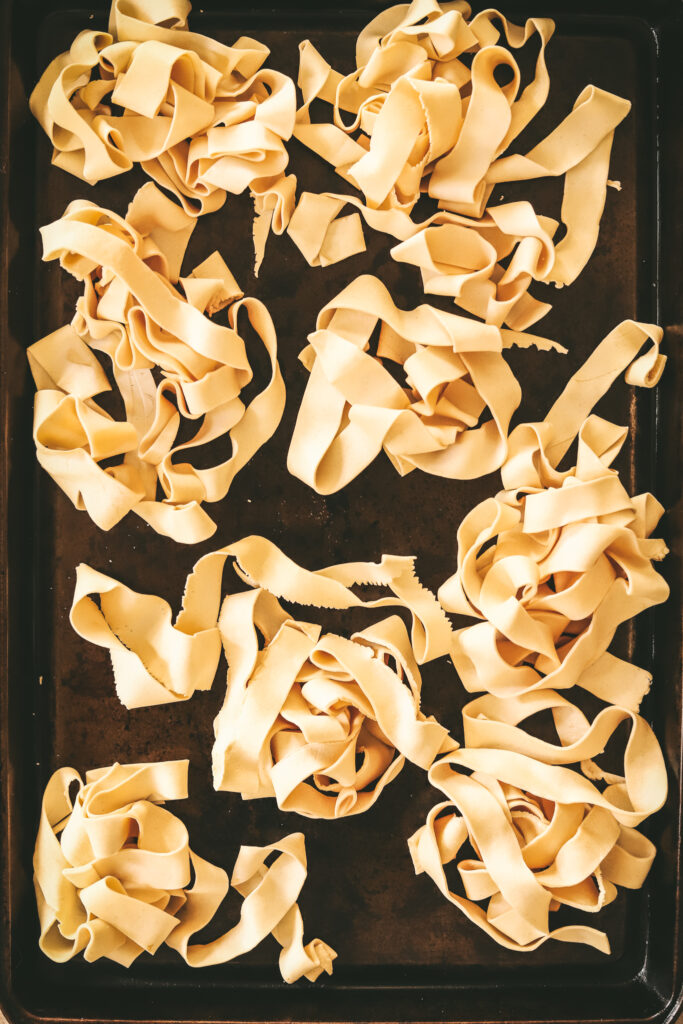 Pappardelle on a baking sheet, now frozen. 