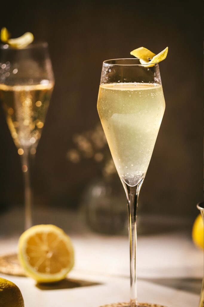 Two French 75 cocktails with lemon peel. 