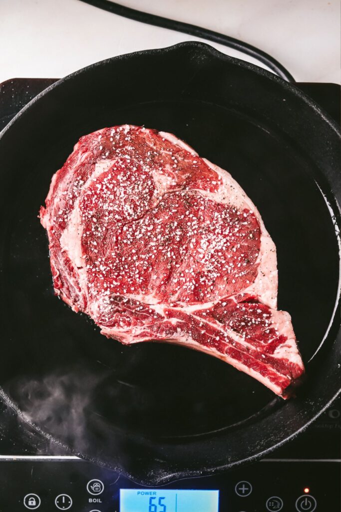 Putting the steak into a smoking hot pan with olive oil, and sear. 