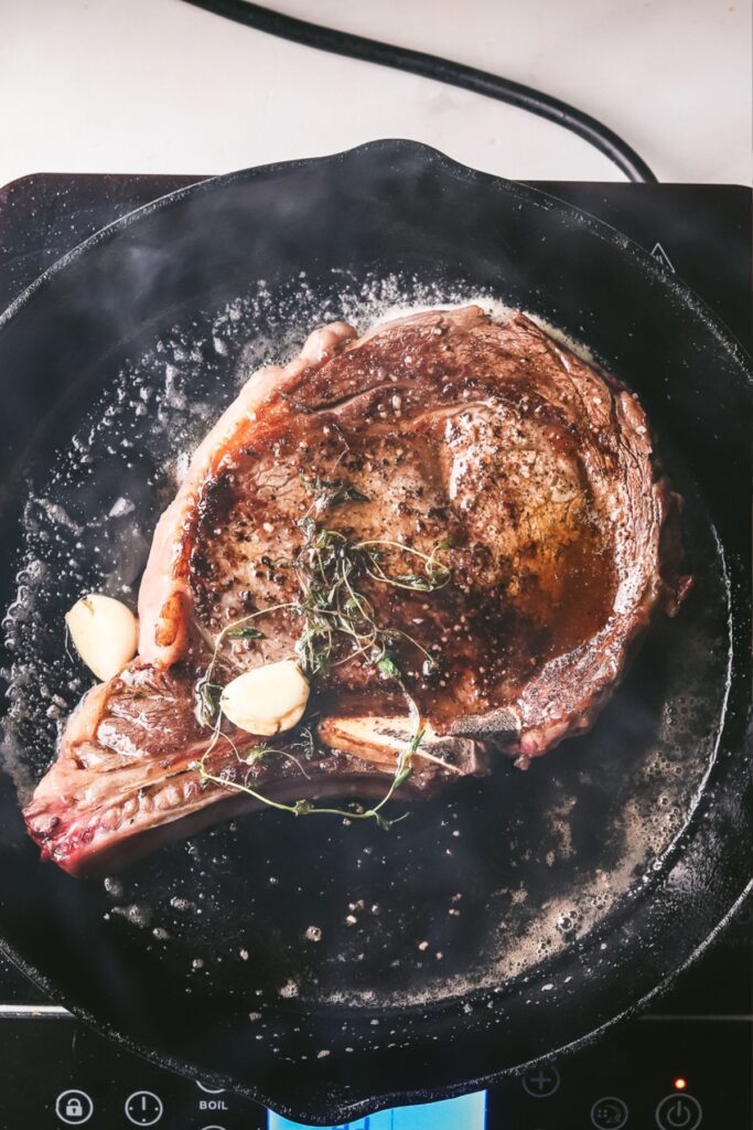 Basting the steak with butter, garlic, thyme. 