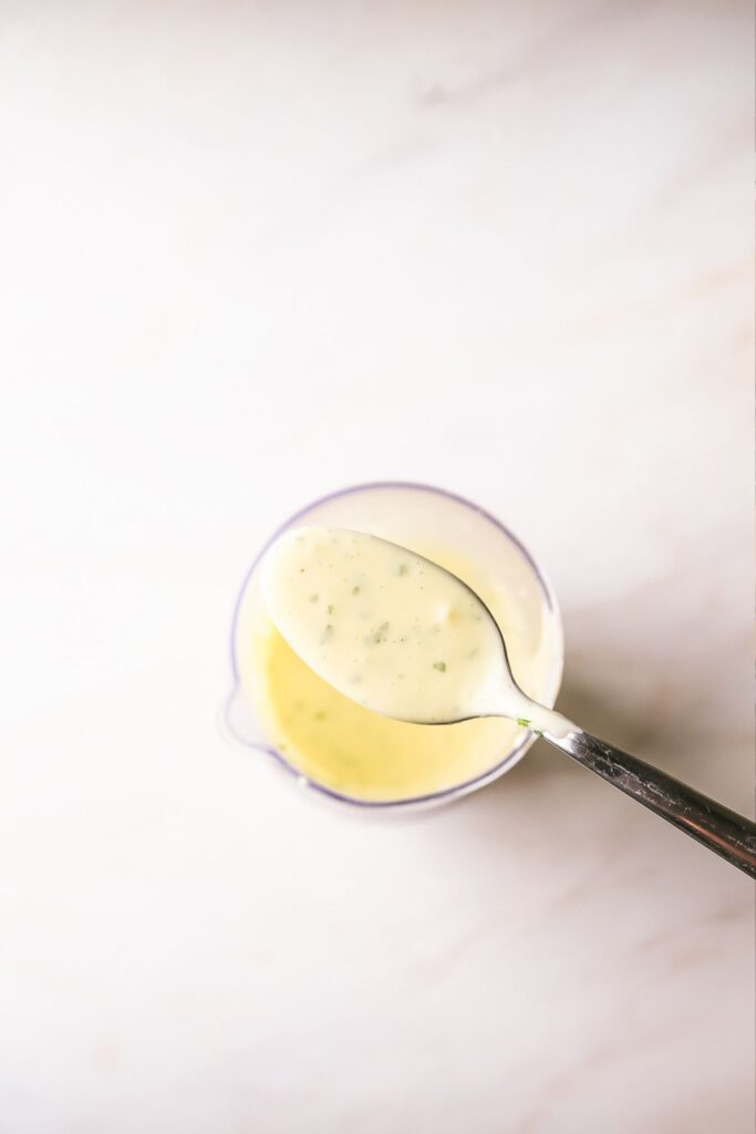 Showing a spoonful of the completed Béarnaise sauce. 