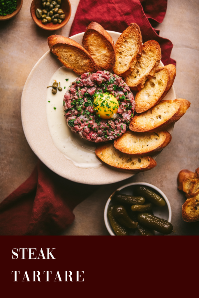 Steak tartare with red wine, on a burgundy background with title text.