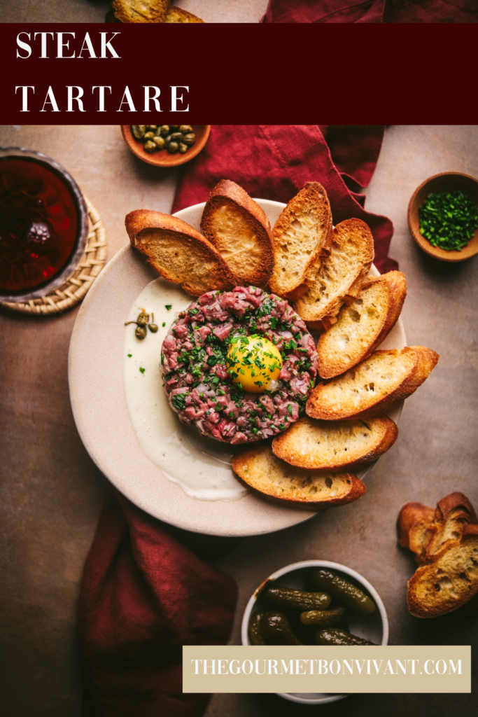 Steak tartare with red wine, on a burgundy background with title text.