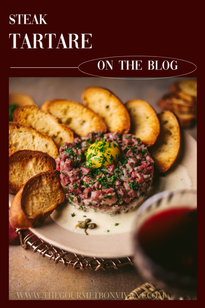 Steak tartare with red wine, on a burgundy background with title text.