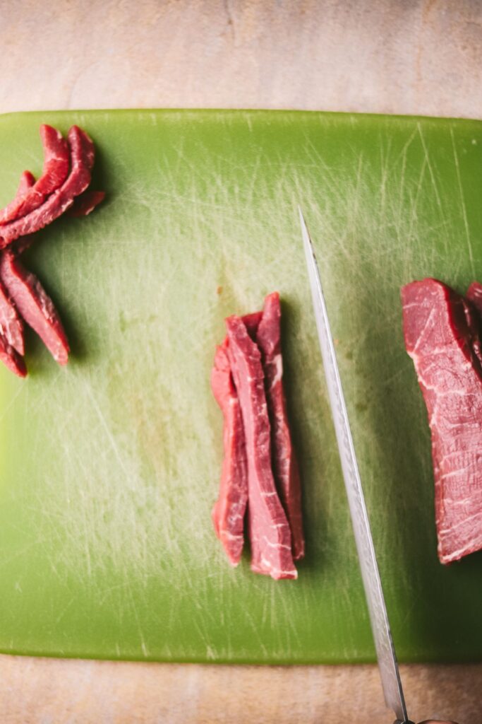 Start by slicing your steak into ¼"  strips.