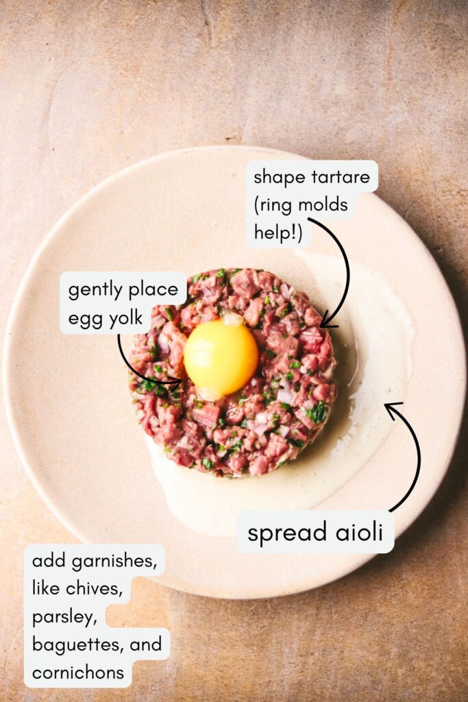 A photo showing how to plate the steak tartare, including spreading the aioli, shaping the tartare, and garnishing with egg yolk.