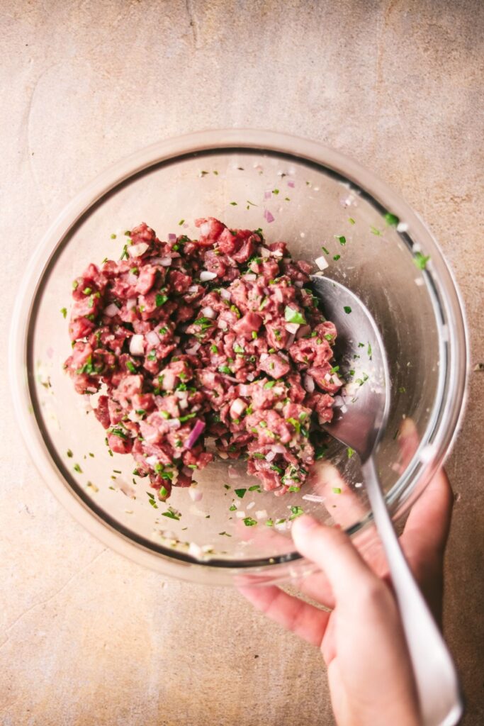 Gently mixing the ingredients in a bowl. 