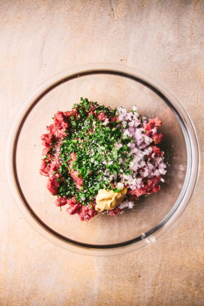 Adding the steak tartare ingredients. 